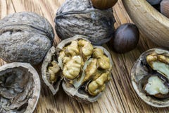 Walnuts and hazelnuts in the split form lie on a wooden background royalty free stock photography Walnuts and hazelnuts in the split form lie on a wooden background royalty free stock photography