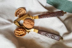 Walnuts and vintage nutcracker with carved wooden handle royalty free stock image Walnuts and vintage nutcracker with carved wooden handle royalty free stock image