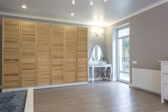 Wardrobe made of thin wooden planks in apartment room. ecological furniture stock photography Wardrobe made of thin wooden planks in apartment room. ecological furniture stock photography