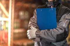 Warehouse worker with blue clipboard closeup photo. stock photography Warehouse worker with blue clipboard closeup photo. stock photography