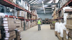 Warehouse worker protection equipment walks by warehouse stock video footage Warehouse worker protection equipment walks by warehouse stock video footage