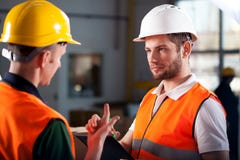 Warehouse workers consulting stock image Warehouse workers consulting stock image