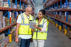 Warehouse workers discussing with digital tablet stock photography Warehouse workers discussing with digital tablet stock photography
