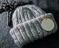 Warm handmade grey winter hat for women with an emty tag on it