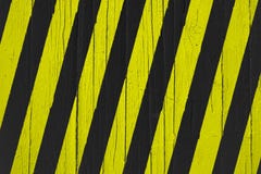 Warning sign yellow and black stripes painted over cracked wood. Royalty Free Stock Image Warning sign yellow and black stripes painted over cracked wood. Royalty Free Stock Image