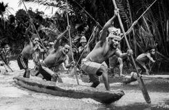 Warriors Asmat tribe are use traditional canoe.