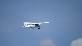WARSAW, POLAND - MAY, 13, 2017. Telephoto lens pan shot of SP-KLP Cessna 172S Skyhawk propeller airplane flying in the stock footage WARSAW, POLAND - MAY, 13, 2017. Telephoto lens pan shot of SP-KLP Cessna 172S Skyhawk propeller airplane flying in the stock footage