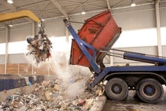 Truck dumps waste to the incinerator, hole where the big grab take the rubbish and put it into fire. All waste is being processed stock photo Truck dumps waste to the incinerator, hole where the big grab take the rubbish and put it into fire. All waste is being processed stock photo