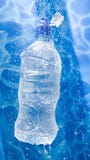 Water bottle in a water splash Water bottle in a water splash