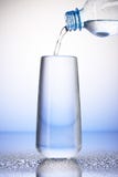Water het gieten van plastic fles in volledig het drinken glas stock afbeeldingen Water het gieten van plastic fles in volledig het drinken glas stock afbeeldingen