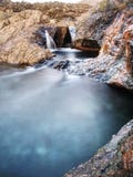 Waterfall between sharp exposed rocks, the Fairy pools on the Isle of Skye Stock Photography Waterfall between sharp exposed rocks, the Fairy pools on the Isle of Skye Stock Photography