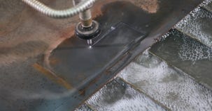 Waterjet CNC machine under pressure cutting elements out of metal sheet