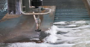 Waterjet metal cutting. Hydroabrasive high pressure CNC machine is cutting metal