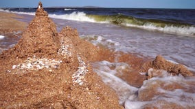 Wave breaks wall of sand the castle