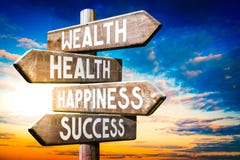 Wealth, health, happiness, success - wooden signpost, roadsign with four arrows