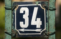 weathered-enameled-plate-number-grunge-square-metal-street-address-closeup-70576029.jpg