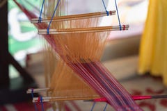 Weaving silk in traditional way with manual loom in Vietnam, closeup Royalty Free Stock Image Weaving silk in traditional way with manual loom in Vietnam, closeup Royalty Free Stock Image