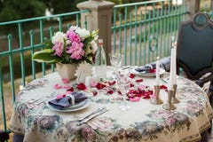 Romantic decor of the festive table in the restaurant with candles, flowers, rose petals royalty free stock photos Romantic decor of the festive table in the restaurant with candles, flowers, rose petals royalty free stock photos