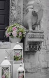 Wedding decoration black and white with colorful elegant bouquet. White boxes with flowers outside church. Elegant bouquet with old church statue. Arrangement stock image Wedding decoration black and white with colorful elegant bouquet. White boxes with flowers outside church. Elegant bouquet with old church statue. Arrangement stock image