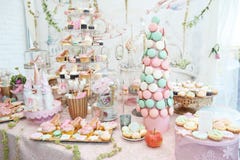 Wedding decoration with pastel colored cupcakes, meringues, muffins and macarons stock photos Wedding decoration with pastel colored cupcakes, meringues, muffins and macarons stock photos