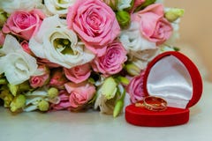 Wedding gold ring. Romantic engagement two diamond rings are in a red box in the shape of a heart, they lie near a stock images Wedding gold ring. Romantic engagement two diamond rings are in a red box in the shape of a heart, they lie near a stock images