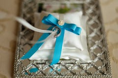 Wedding rings on a cushion with blue ribbon stock images Wedding rings on a cushion with blue ribbon stock images