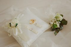 Wedding rings on a white pillow with a delicate bouquet. Romance, holiday. Wedding concept. royalty free stock images Wedding rings on a white pillow with a delicate bouquet. Romance, holiday. Wedding concept. royalty free stock images