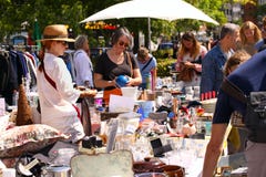 Weekend flea market in the city center on a sunny day. Market booth with objects for sale and People are looking for a good find stock photos Weekend flea market in the city center on a sunny day. Market booth with objects for sale and People are looking for a good find stock photos