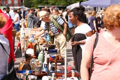 Weekend flea market in the city center on a sunny day. Market booth with objects for sale and People are looking for a good find stock photo Weekend flea market in the city center on a sunny day. Market booth with objects for sale and People are looking for a good find stock photo