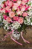 Weergeven van een boeket van verse pastelkleur roze rozen met een roze boog op rustieke houten achtergrond stock foto Weergeven van een boeket van verse pastelkleur roze rozen met een roze boog op rustieke houten achtergrond stock foto
