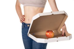 Weight loss and healthy eating or dieting concept. Slim girl with open pizza box and red apple in it. stock images Weight loss and healthy eating or dieting concept. Slim girl with open pizza box and red apple in it. stock images