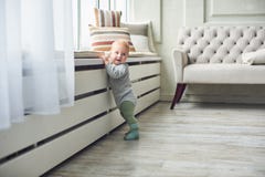 Weinig 8 van de babymaanden jongen bevindt zich thuis met steun dichtbij venster in witte ruimte stock foto's Weinig 8 van de babymaanden jongen bevindt zich thuis met steun dichtbij venster in witte ruimte stock foto's