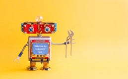 Welcome to industry 4.0 concept. IT specialist steampunk machinery robot, smiley red head, blue monitor body, pliers royalty free stock photos Welcome to industry 4.0 concept. IT specialist steampunk machinery robot, smiley red head, blue monitor body, pliers royalty free stock photos