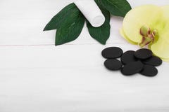 Wellness background with orchid flowers and spa tools: cream, lotion, towel and stock image Wellness background with orchid flowers and spa tools: cream, lotion, towel and stock image