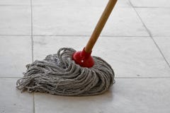 Wet mop on dirty tile stock images Wet mop on dirty tile stock images