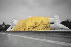 Full view of large Mya Tha Lyaung Reclining or sleeping Buddha in black and white with yellow robe Royalty Free Stock Images Full view of large Mya Tha Lyaung Reclining or sleeping Buddha in black and white with yellow robe Royalty Free Stock Images