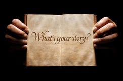 What`s your story? hands holding an open book background