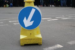 White arrow on blue traffic sign on road stock photos White arrow on blue traffic sign on road stock photos