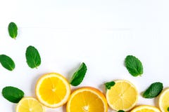 White background with lemon, orange slices and mint. Concept with fresh fruit. Lemon, Orange, Mint. View from above royalty free stock image White background with lemon, orange slices and mint. Concept with fresh fruit. Lemon, Orange, Mint. View from above royalty free stock image