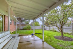 White bench in Utah backyard with tree stock image White bench in Utah backyard with tree stock image