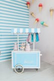 White and blue ice cream cart. Food truck. Shop on wheels with the sweets. Candy stall photo zone with sweets cone and blue and wh