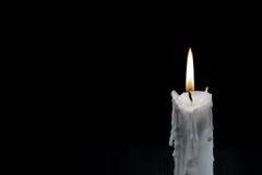 White candle on dark background. Memory photo. One candle with fire on black. In memoriam banner template