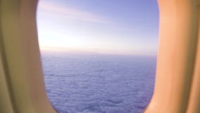 White cloud in sky view from airplane window while golden sunrise. View from window flying aircraft sunset in cloudy sky