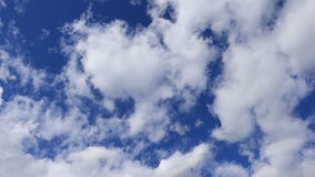 White clouds float smoothly across the sky. stock footage White clouds float smoothly across the sky. stock footage