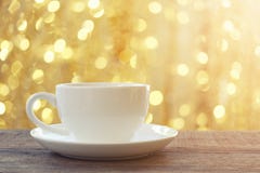 White coffee mug on brown wooden floor and have bokeh light back Stock Image White coffee mug on brown wooden floor and have bokeh light back Stock Image