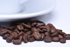 White Cup Of Coffee And Coffee Beans Stock Photography