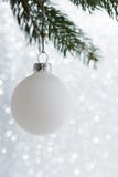 White decorative ball on the xmas tree on glitter bokeh background. Merry christmas card. stock photos White decorative ball on the xmas tree on glitter bokeh background. Merry christmas card. stock photos
