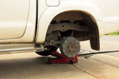 A white dirty car without a tyre in repairing process. royalty free stock photography A white dirty car without a tyre in repairing process. royalty free stock photography