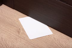 white-envelope-message-slipped-under-wooden-door-blank-paper-to-write-nested-gap-door-see-my-other-36182576.jpg