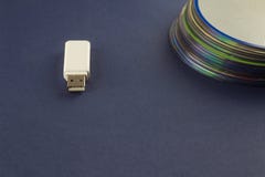 White flash drive and a stack of CD, DVD, computer, White flash drive and a stack of CD, DVD, computer royalty free stock photography White flash drive and a stack of CD, DVD, computer, White flash drive and a stack of CD, DVD, computer royalty free stock photography